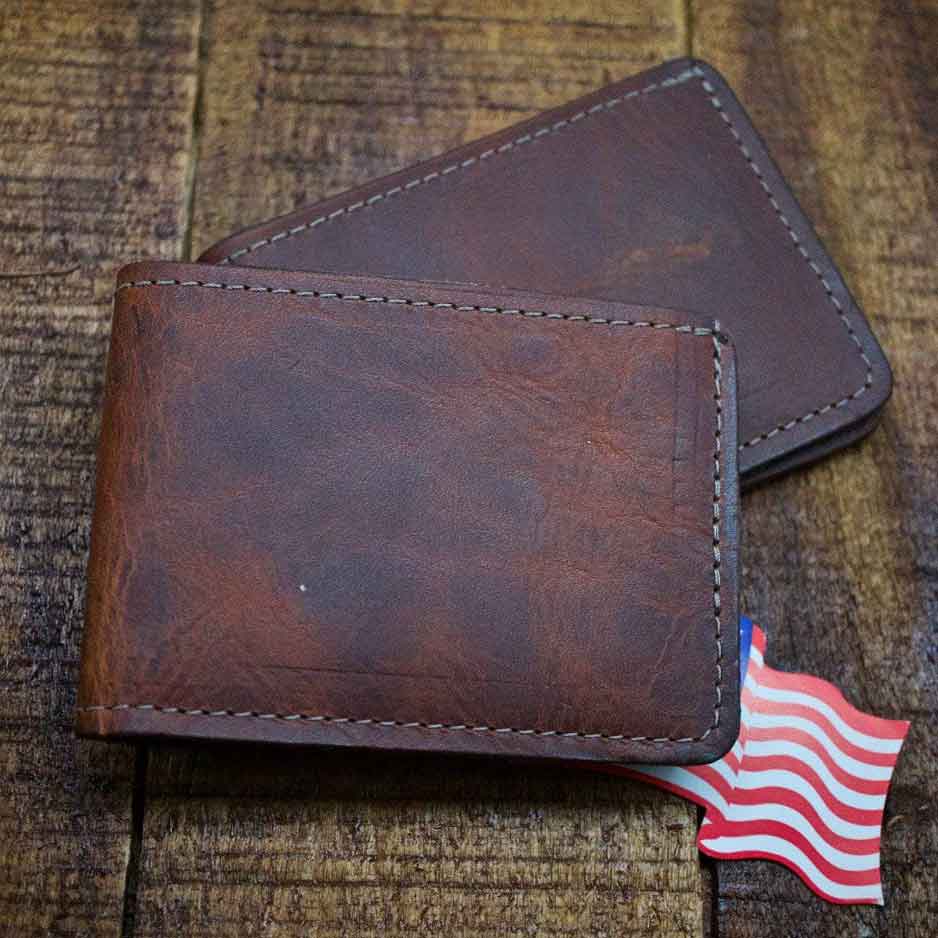 Charleston Bourbon Brown Leather Bifold Wallets on Wood Panel