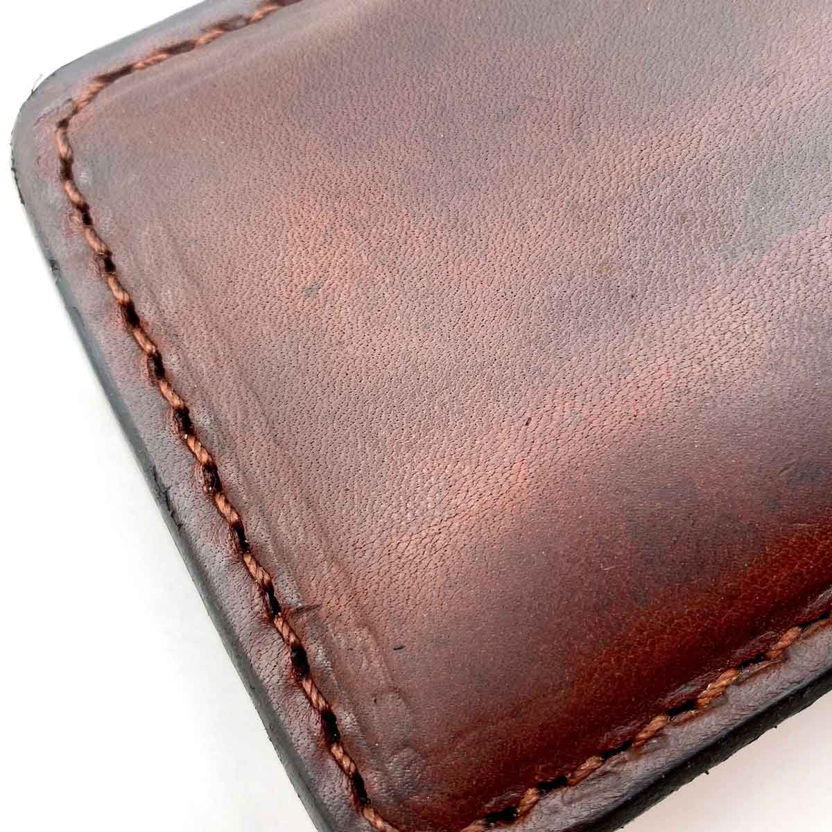 Close up of leather grain and stitching on Mohogany Minimalist wallet