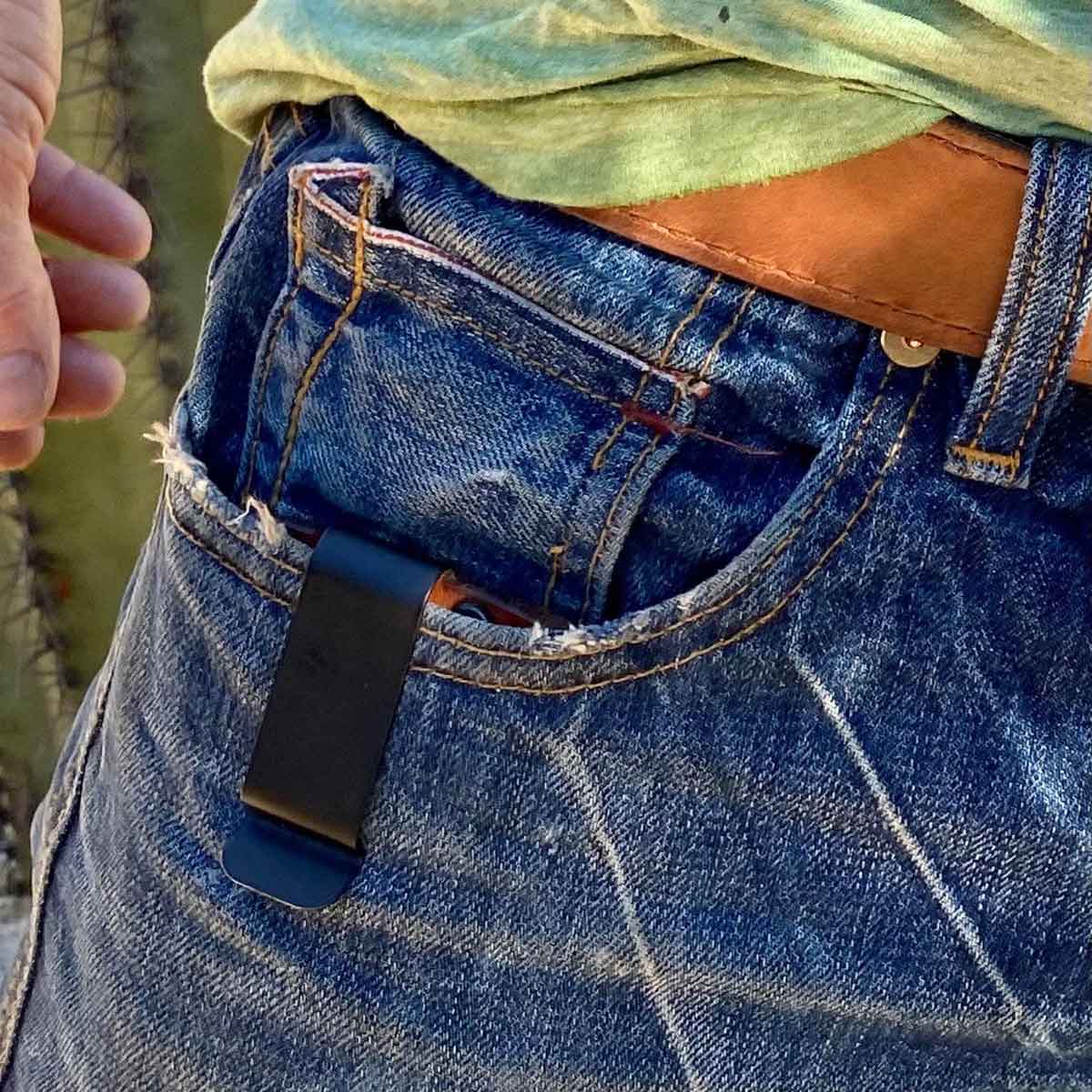 Minimalist wallet in pocket of blue jeans.